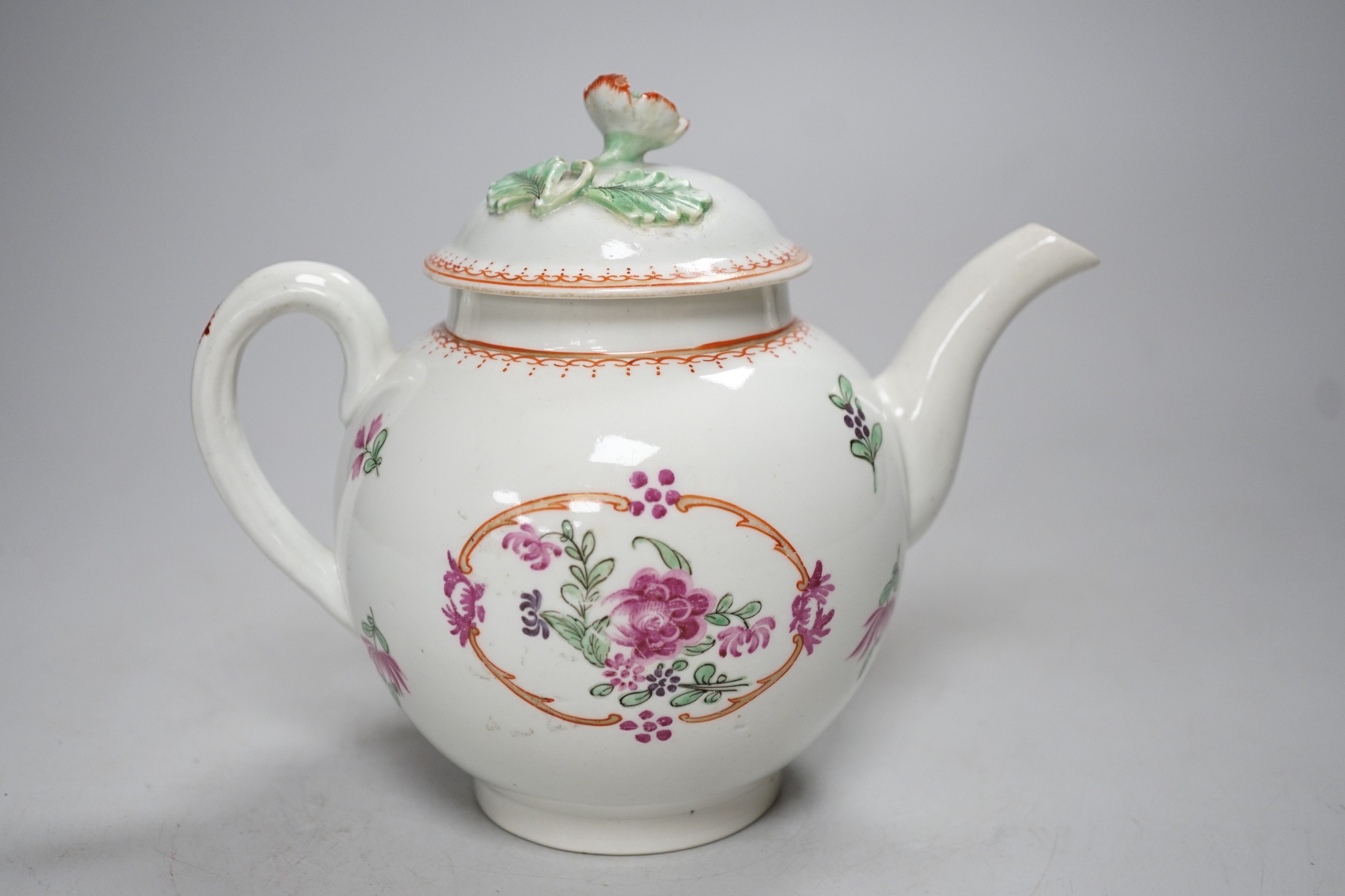 An 18th century Worcester teapot and cover painted in Chinese export style with flowers in an oval panel. 16cm tall